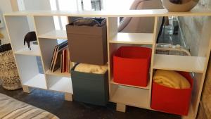 a book shelf filled with lots of boxes at Modern lofty studio in Midtown / Charming Old SW in Reno
