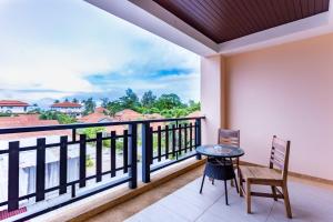 a balcony with a table and chairs and a view at Lanta Garden Hill Resort and Apartment in Ko Lanta