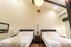 A bed or beds in a room at The Riverside Inn