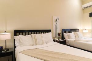 A bed or beds in a room at The Riverside Inn