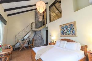 A bed or beds in a room at The Riverside Inn