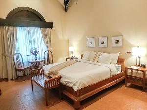A bed or beds in a room at The Riverside Inn