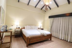 A bed or beds in a room at The Riverside Inn