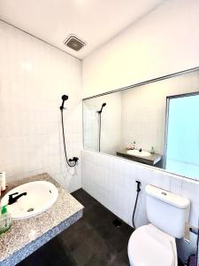 a bathroom with a white toilet and a sink at Best Canggu Hostel in Canggu