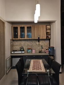 eine Küche mit einem Glastisch und einer Arbeitsplatte in der Unterkunft Villa Asri in Batu