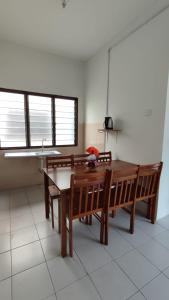 a kitchen with a table and benches and a sink at Pusing Holiday Apartment in Pusing