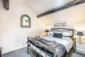 a bedroom with a bed and a mirror at Bwthyn Y Nant in Dinorwic