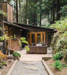 a house in the woods with a large patio at Sur Grove Big Sur in Big Sur