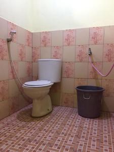 uma casa de banho com um WC e uma lata de lixo em Garser em Yogyakarta