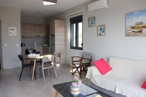 a living room with a white couch and a table at Triopetra View 2 in Triopetra