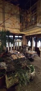 a room with tables and plants in a building at My Rialto Palace in Venice