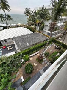 an aerial view of a building with a garden and the ocean at Stardust Boutique Hotel in Hua Hin