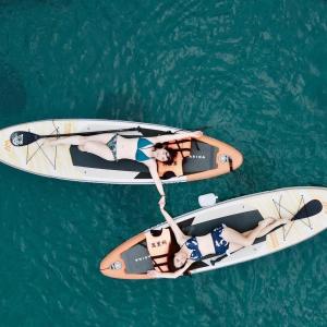 two women are riding on a boat in the water at 山森三室墾丁南灣包棟民宿3Rooms in Nanwan