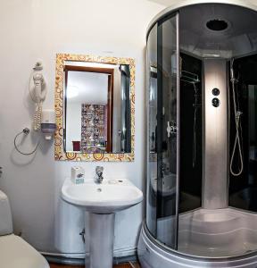 a bathroom with a sink and a shower at Globus Hotel in Perm