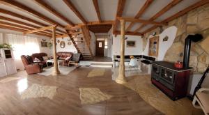 a living room with a fireplace and a stone wall at Apartments Nostalgia in Trogir