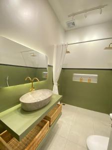 a bathroom with a sink and a toilet at Karabineri Private Pool Jogja Villa in Ngaglik +16 photos