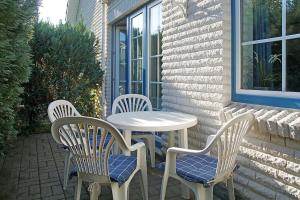 a white table and chairs sitting on a patio at Haus Weisse Möwe Weisse Möwe 3 in Cuxhaven +8 photos