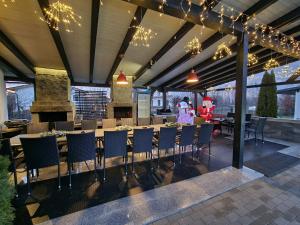 a restaurant with tables and chairs and chandeliers at Cabana Supporter -Supporter Chalet in Porumbacu de Sus