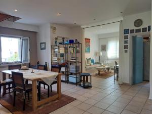 a dining room and living room with a table and chairs at Meraki in Selianitika