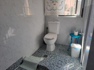a bathroom with a toilet and a blue tiled floor at To MEROS 1 in Selianitika