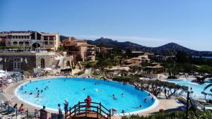 duży basen w ośrodku z osobami w nim w obiekcie APPARTEMENT CAP ESTEREL CLIMATISE VUE MER w mieście Agay - Saint Raphael