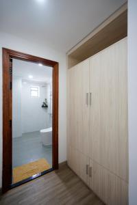 uma casa de banho com uma porta que leva a um WC em Moonlight Nha Trang Hotel em Nha Trang