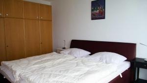 a bed with two white pillows on it in a bedroom at Haus Seehütte Seehütte Haus 2 Wohnung 103 in Cuxhaven