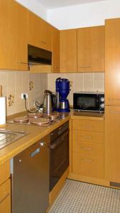 a kitchen with a microwave and a stove top oven at Haus Seehütte Seehütte Haus 2 Wohnung 103 in Cuxhaven