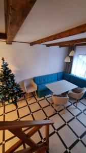 a living room with a blue couch and a christmas tree at 12 Місяців-Травень, басейн з підігрівом in Slavske