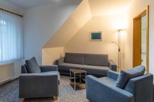 a living room with a couch and two couches at Haus Relax Appartements Duhnen Haus Relax Appartements Duhnen - Wohnung 2 in Cuxhaven