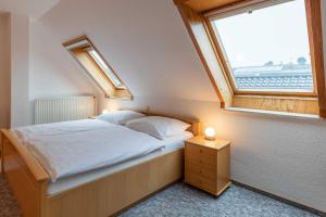 a bedroom with a bed and a window at Haus Relax Appartements Duhnen Haus Relax Appartements Duhnen - Wohnung 2 in Cuxhaven