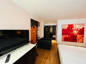 a bedroom with two beds and a flat screen tv at Baipho Lifestyle in Patong Beach