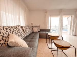 a living room with a couch and two tables at Villa Julia in Callao Salvaje in Callao Salvaje