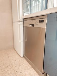 a dishwasher in a kitchen next to a refrigerator at Villa Julia in Callao Salvaje in Callao Salvaje
