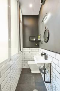 a white bathroom with a sink and a toilet at Serrano Style, by Presidence Rentals in Madrid