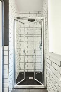 a shower with a glass door in a bathroom at Serrano Style, by Presidence Rentals in Madrid