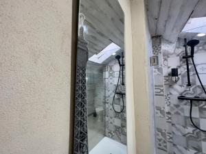 a mirror in the hallway of a building at G-house in Parma