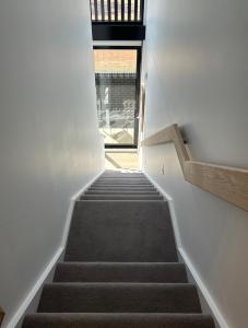 a staircase leading up to a building with a window at New & Modern Loft 1bd w/Pool&Gym in Canberra