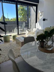 sala de estar con mesa de cristal y sillas en New & Modern Loft 1bd w/Pool&Gym, en Canberra