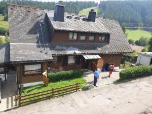 a group of people standing in front of a house at Haus Gretel in Feldberg