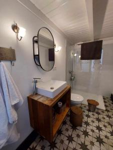 a bathroom with a sink and a mirror and a toilet at CASA YOOJ designers house in teguise in Teguise