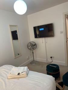 a bedroom with a bed and a flat screen tv at Modern 2bedrooms in woolwich in Woolwich