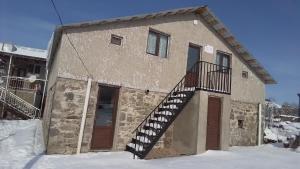 a building with a staircase on the side of it at Agro House Mezge - აგროსახლი მეზგე in Bashkʼo