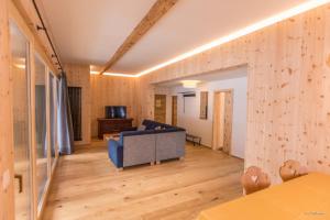 a living room with a couch and a television at Hotel Münsterhof in Müstair