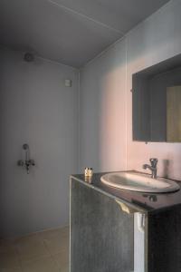 a bathroom with a sink and a mirror at Palolem Beach Resort in Palolem