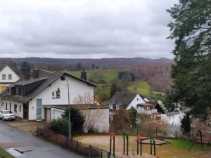 a view of a town with houses and a playground at In Kadenbach, Schöne Ferienwohnung im ruhigen in Kadenbach