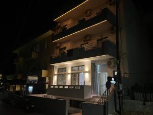 a building at night with lights on the side of it at Charm Hotel, Hersonissos in Hersonissos