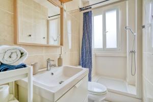 a bathroom with a sink and a toilet and a shower at My Cosy Home 1 in Vitry-sur-Seine