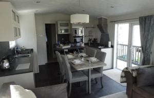 a kitchen and living room with a table and chairs at Ash Retreat Hot Tub in Swarland