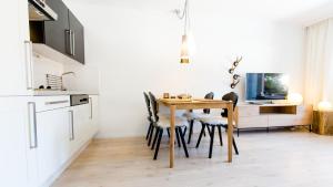 a kitchen with a table and chairs in a room at Alpenoase in Farchant